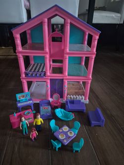 Three story dollhouse with furniture and dolls