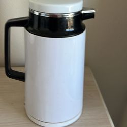 A.K. Das thermal vacuum carafe.  It is a white, 4-cup capacity vacuum flask. The carafe is designed to keep beverages hot or cold. It is a vintage ite