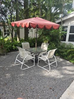Patio table chairs and umbrella