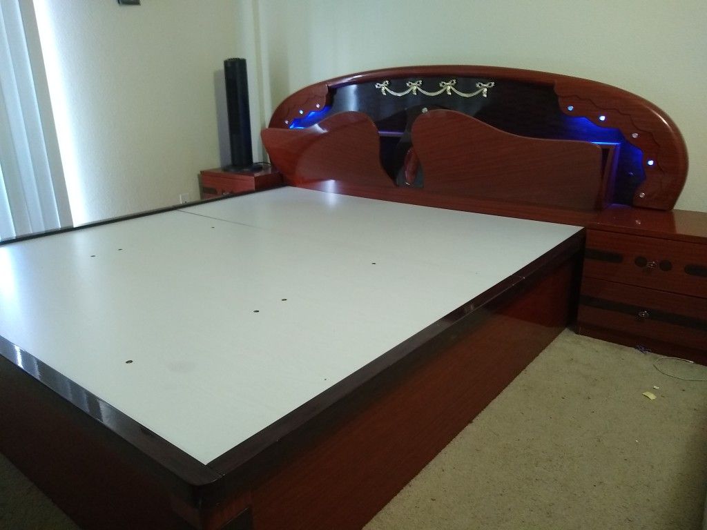 King size wooden bed frame well polished with two side cabinets(negotiable)