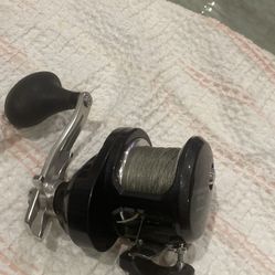 Awesome Shimano Torium 16HG fishing reel. Black body with a silver handle. Has Spectra line spooled on it. 