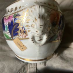 small, antique porcelain cachepot or sugar pot with a hand-painted, colorful floral design and gold accents.