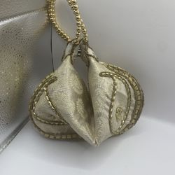 Vintage gold, clamshell, fortune cookie style purse, heavy material very nice bought in Dubai