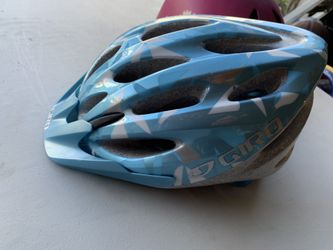 2 girls helmets and bike gloves