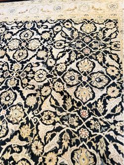Woolen hand made rug. Made in India. Needs to be washed. Pet free smoke free home.