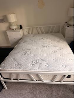Queen size mattress with white metal bed frame