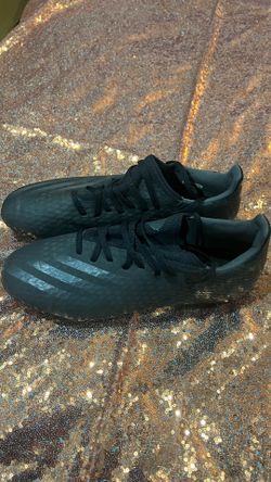 . Black Adidas soccer cleats, size 9, worn once.