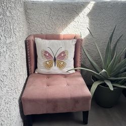 Pink chair and pink Queen bed