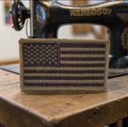Subdued Olive Drab OD Green American USA Flag Patch Hook Fastener Tactical Patch. 
This appears to be a subdued olive drab American flag patch, likely