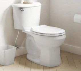 American Standard Reliant 12 in. Rough In 2-Piece 1.28 GPF Single Flush Round Toilet with Slow Close Seat in White
