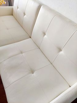 White futon convertible sofa. 76 inches long.