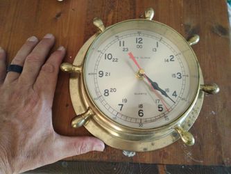 Solid brass ships wheel clock.