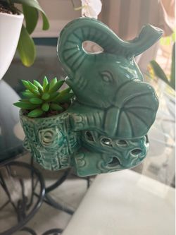 Green Ceramic elephant with tusk , floppy ears, and interesting tear trap and Hart carve outs.