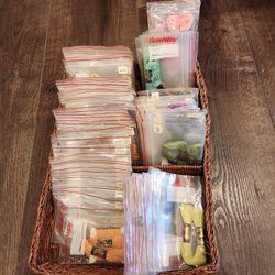 collection of embroidery floss, 67 bags of DMC embroidery floss in colors stored in a "Floss-Away" brand protective plastic bags in basket