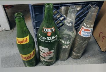 A crate full of vintage soda bottles