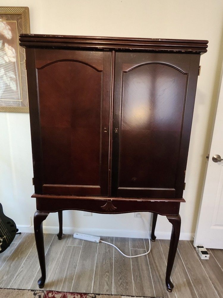 Vintage wood entertainment center - armoire with two doors and a stand.