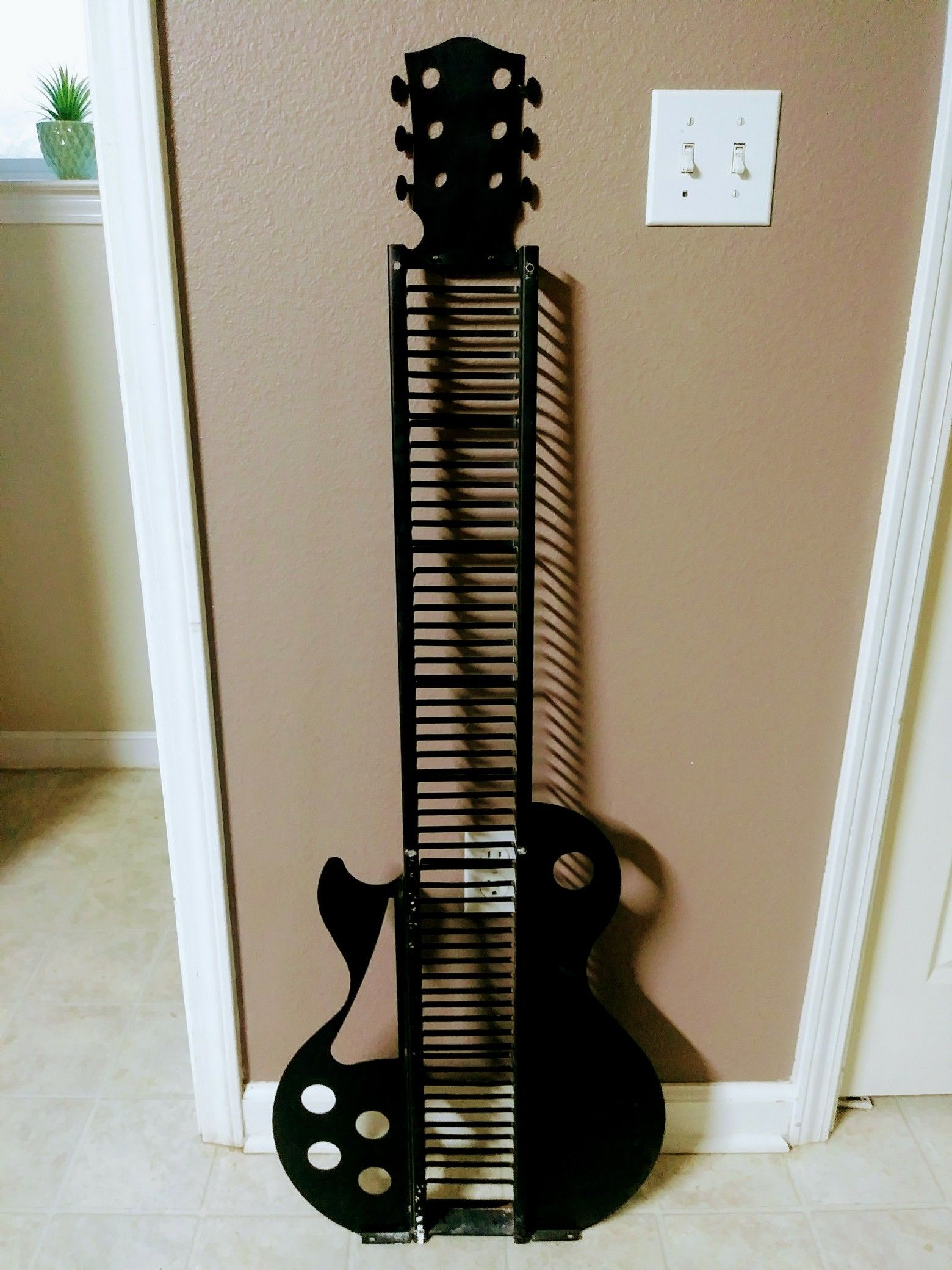Decorative guitar shaped dvd or cd holder