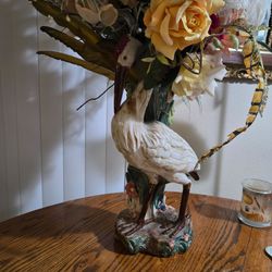Crane vase with flower arrangement