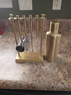 A Gold Medal Bar Tool Set With A Gold Cocktail Shaker