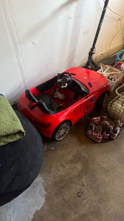 Red Kids Ride-On Electric Car and small toys