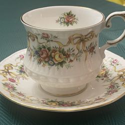 Vintage Queen's fine bone china teacup and saucer with floral pattern.