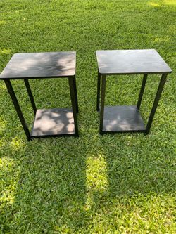 Two matching black wood and metal tables