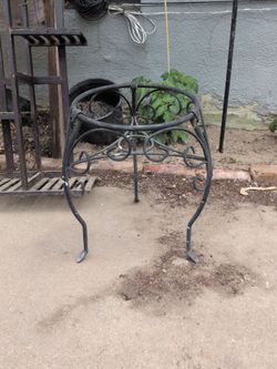 vintage wrought iron plant stand featuring decorative scrollwork