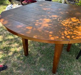 Wooden extended table with chairs