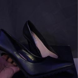 Black leather high heels with a chunky heel