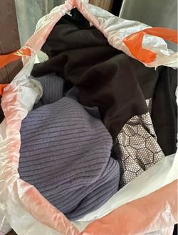 Assorted bag full of women’s clothes and shoes