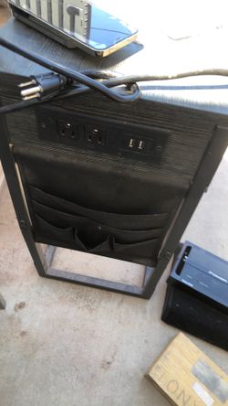 The highlighted item is a C-shaped end table with a built-in charging station and storage organizer pockets
