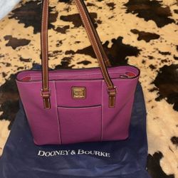 Light plum Dooney & Bourke handbag pebble grain with brown details; zipper close