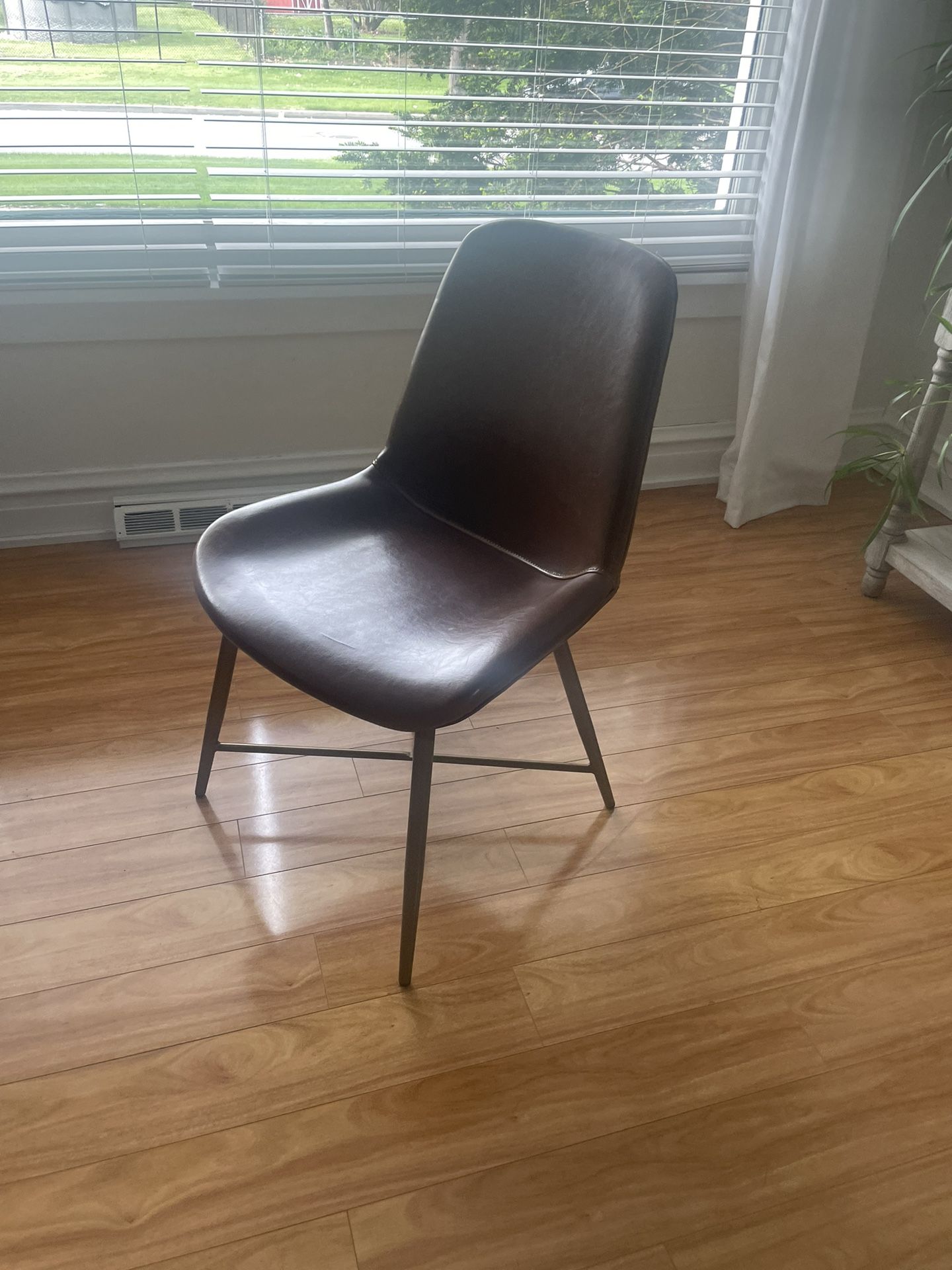 Contemporary Leather Chair with metal frame, from Workd Market, solid and sturdy, $20