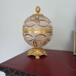 Spherical glass confectioner with wheel decoration.