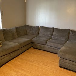Gray Sectonional With Ottaman And Two Pillows
