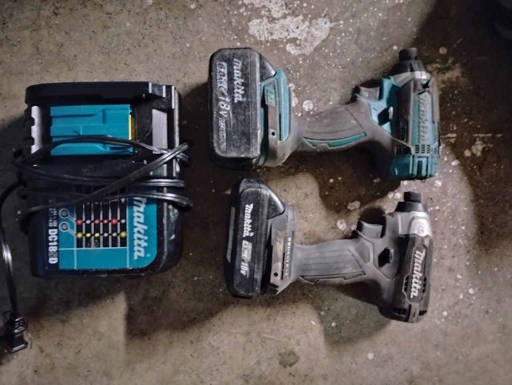 Two Makita Impact Drills And Charger
