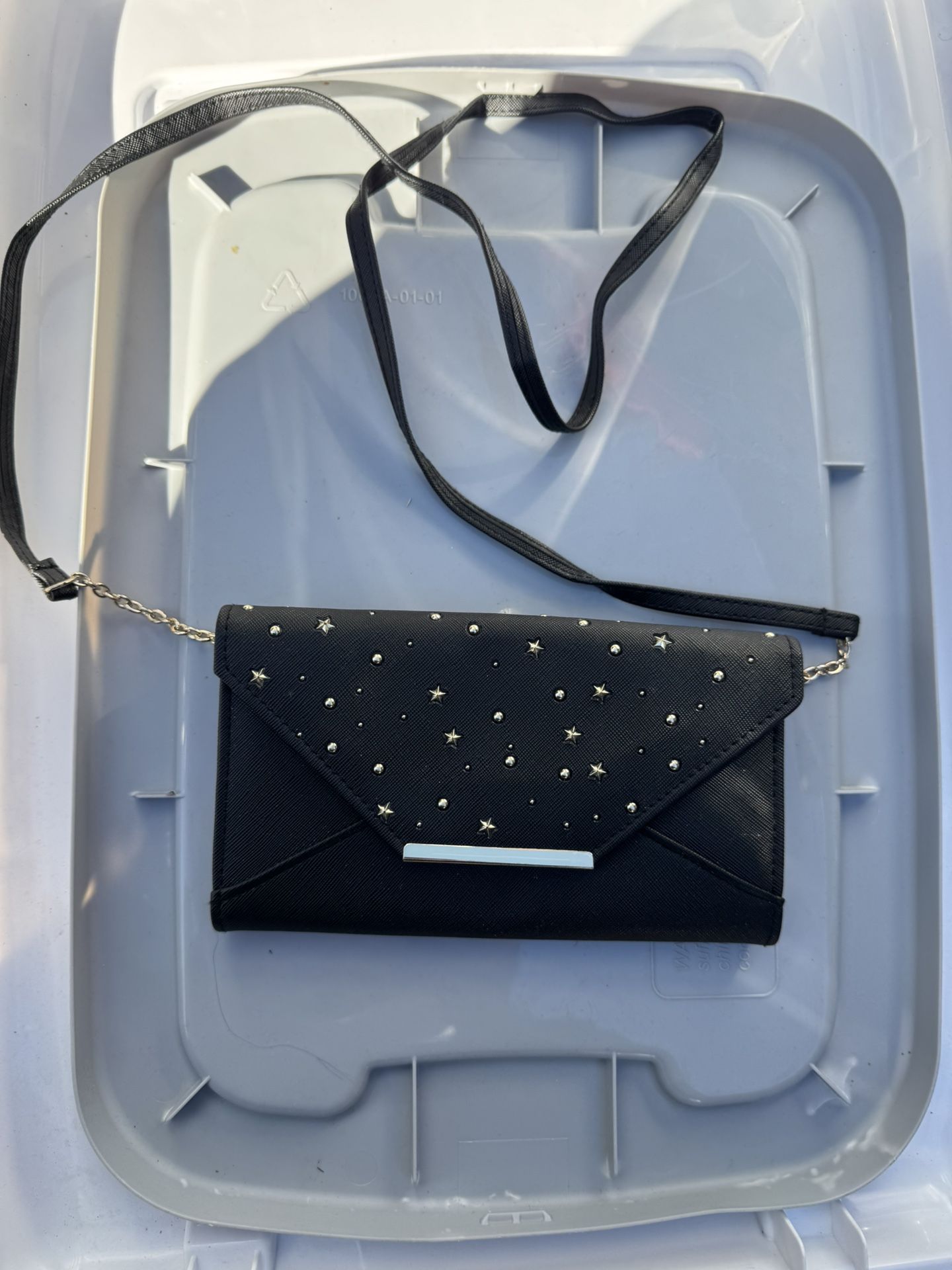  black clutch bag with a studded star pattern.