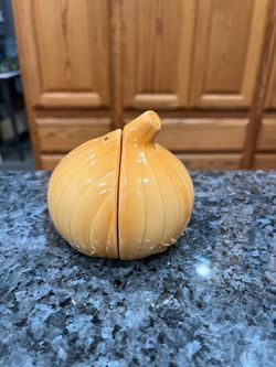 Vintage Ceramic Onion Pair of Salt And Pepper Shakers.  Size approximately 3 1/2 inches wide and 3 inches tall.  Preowned.  Has been on display in a c
