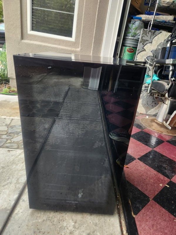 Freestanding Frigidaire wine or beverage fridge with light. 33” high x 17.5 deep x 19 wide.
