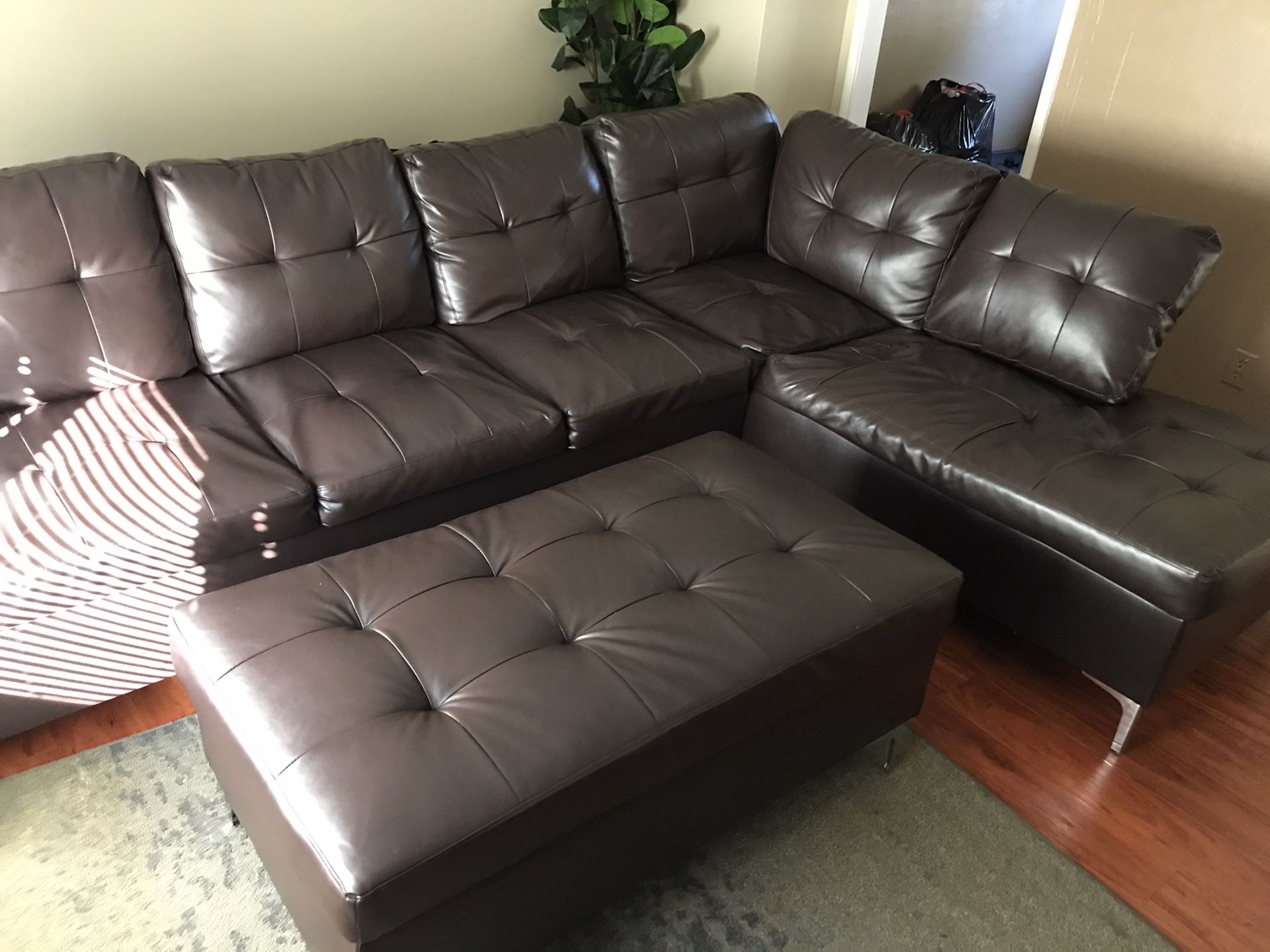 Like new brown leather sectional and ottoman