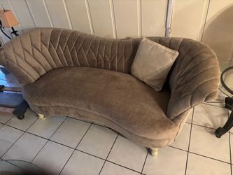 Gray Dolent velvet kidney sofa features a curved, quilted back … 65 “ wide .  $100