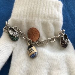 Firenza Baby Shoes Charm Bracelet Adorable bracelet in Sterling Silver. Has 3 baby shoes adorned with tiny colored crystals& palm tree,Solid bracelet