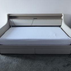 Cream colored day bed with underside storage
