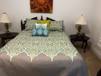 Dark wood bed frame, very comfortable queen sized mattress along with comforter and pillows shams