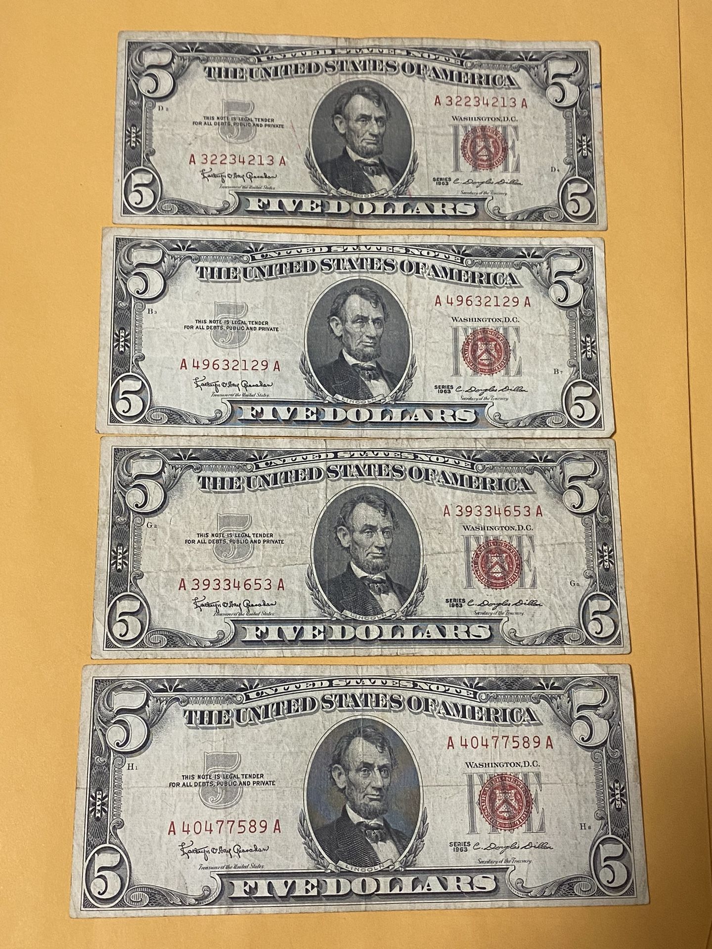 I am selling four collectible red five-dollar bills from the same year, 1963. I am asking for $25 each, the price is firm.