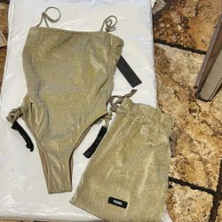 Gold one piece set with matching bag from Triangl.  This stunning bathing suit will definitely give you lots of compliments.  Size XS.  See pictures N