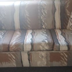 bed/sofa and a fridge 