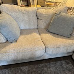 light tan/cream love seat w 2 pillows