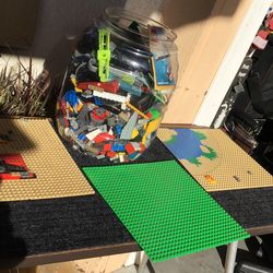 Plastic container full of Lego bricks and bases to build