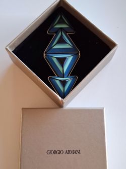 Giorgio Armani branded box containing a stylized, geometric blue and green crystal artifact. 4.5”